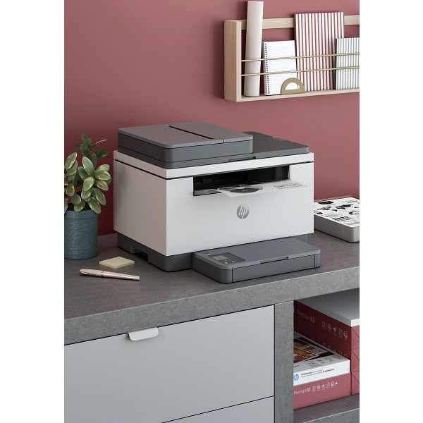 HP LaserJet MFP M232-M237 Light Basalt, Network Right facing on desk against maroon wall, vertical orientation