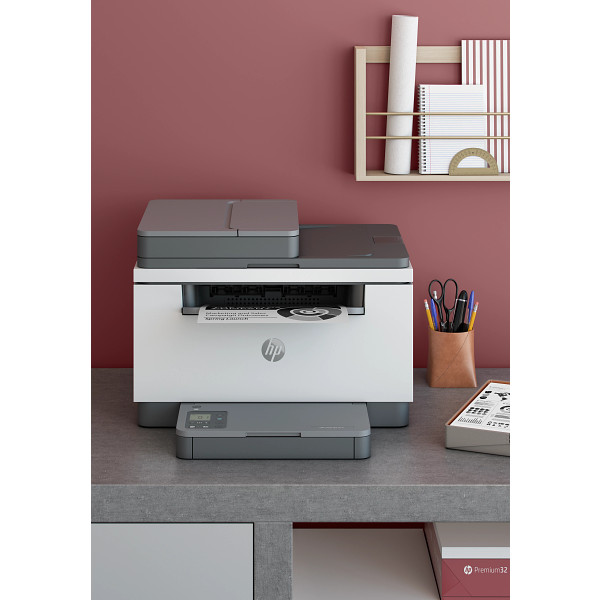 HP LaserJet MFP M232-M237 Light Basalt, Wireless Front facing on desk against maroon wall, vertical orientation
